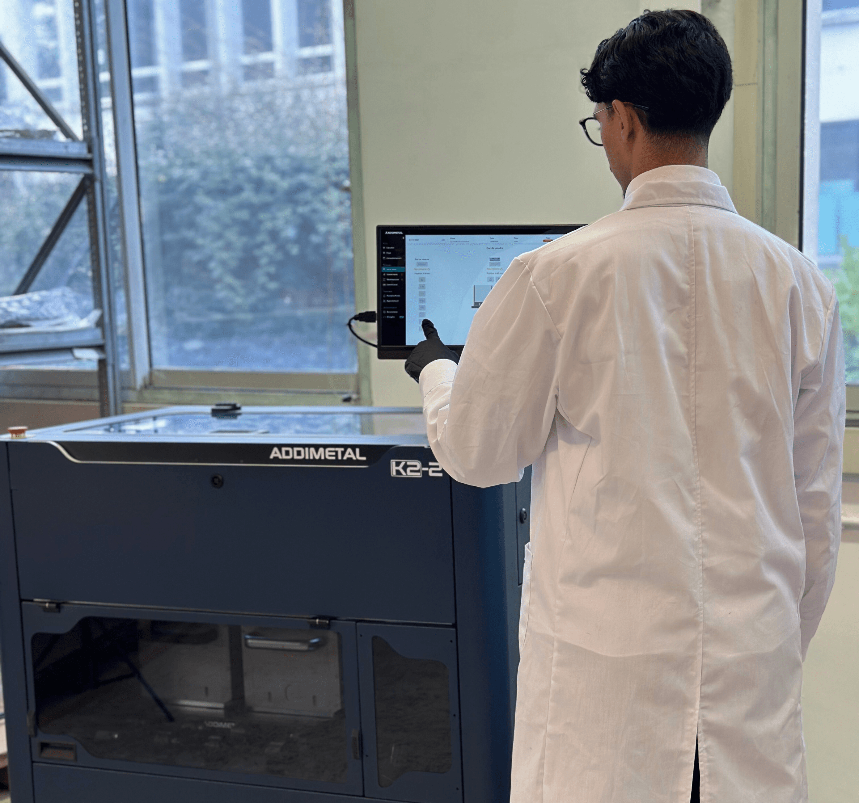 Operator controlling Addimetal's K2-2 metal 3D printer using Orion software